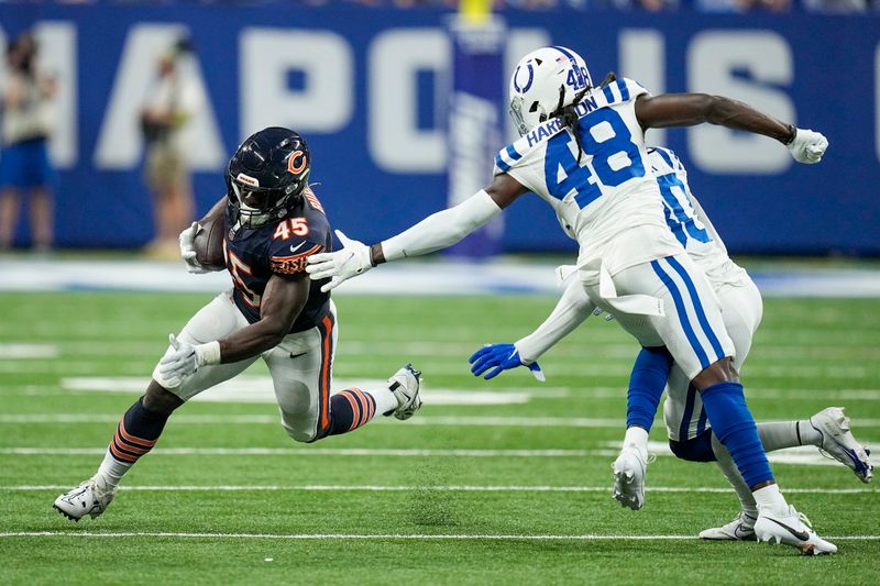 Chicago Bears fullback Robert Burns (45) runs around Indianapolis Colts safety Ronnie Harrison Jr. (48) during the second half of an NFL preseason football game in Indianapolis, Saturday, Aug. 19, 2023. (AP Photo/Darron Cummings)