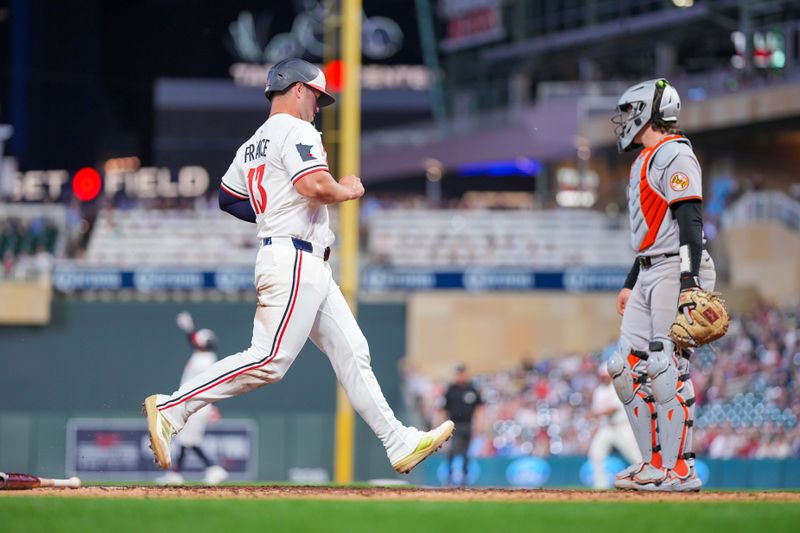 May 6, 2025; Minneapolis, Minnesota, USA; Minnesota Twins first base Ty France (13) scores against the Baltimore Orioles in the seventh inning at Target Field. Mandatory Credit: Brad Rempel-Imagn Images
