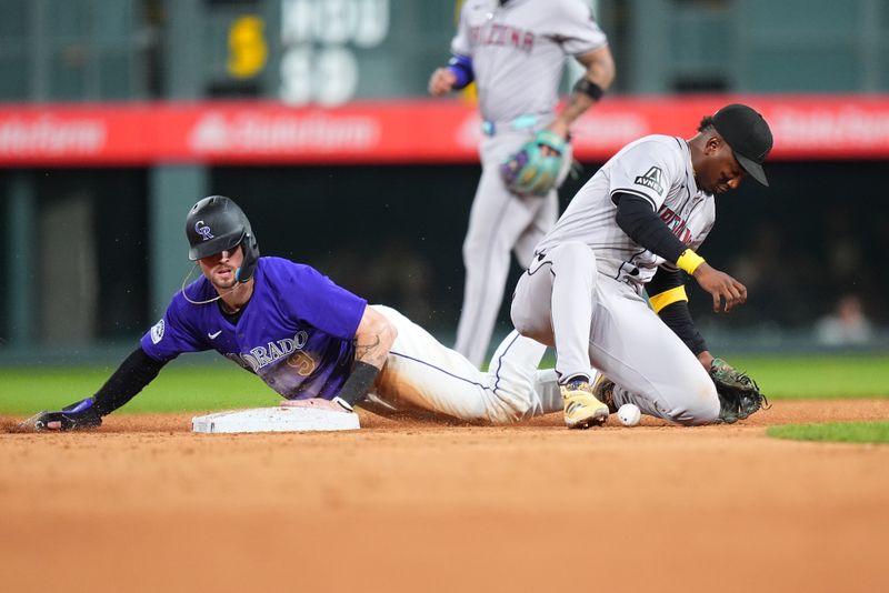 Sep 16, 2024; Denver, Colorado, USA; Arizona Diamondbacks second base Ketel Marte (4) is unable to field the ball as Colorado Rockies outfielder Brenton Doyle (9) steals second in the ninth inning at Coors Field. Mandatory Credit: Ron Chenoy-Imagn Images