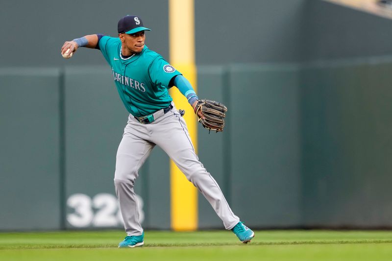 May 8, 2024; Minneapolis, Minnesota, USA; Seattle Mariners second baseman Jorge Polanco (7) throws the ball to first base for an out against the Minnesota Twins in the first inning at Target Field. Mandatory Credit: Jesse Johnson-USA TODAY Sports