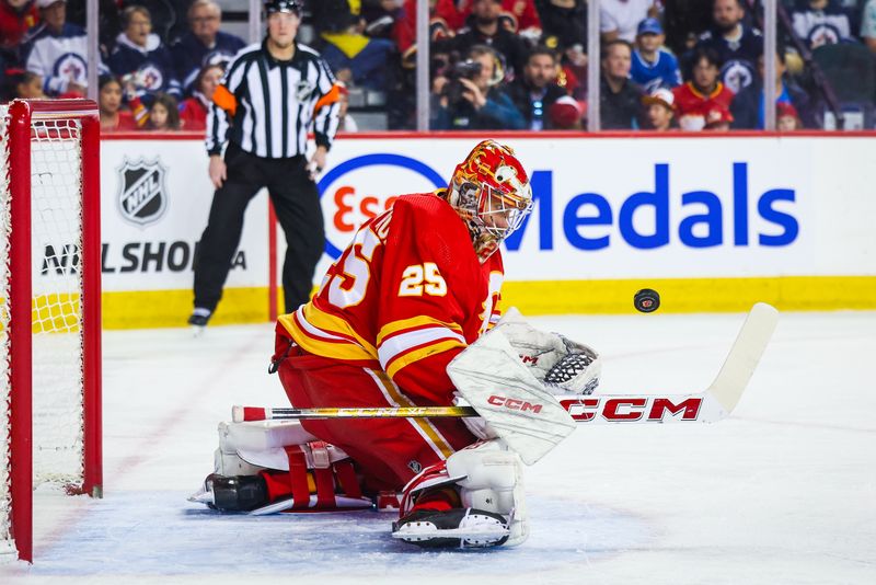 Feb 19, 2024; Calgary, Alberta, CAN; Calgary Flames goaltender Jacob Markstrom (25) makes a save against the Winnipeg Jets during the first period at Scotiabank Saddledome. Mandatory Credit: Sergei Belski-USA TODAY Sports