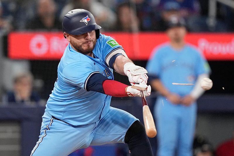 May 4, 2025; Toronto, Ontario, CAN; Toronto Blue Jays catcher Alejandro Kirk (30) breaks his bat as he hits a single against the Cleveland Guardians during the eighth inning at Rogers Centre. Mandatory Credit: John E. Sokolowski-Imagn Images