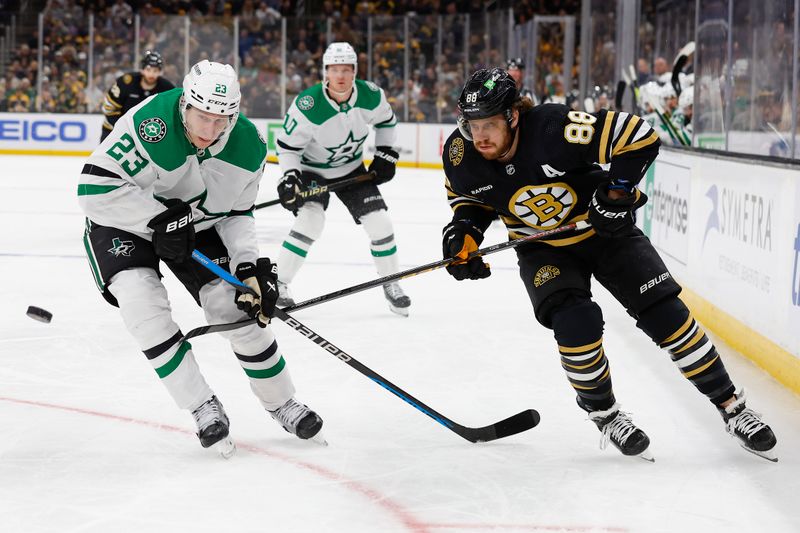 Feb 19, 2024; Boston, Massachusetts, USA; Dallas Stars defenseman Esa Lindell (23) and Boston Bruins left wing David Pastrnak (88) eye a loose puck during the first period at TD Garden. Mandatory Credit: Winslow Townson-USA TODAY Sports