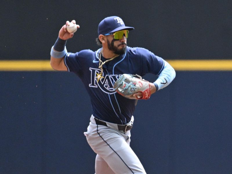 May 1, 2024; Milwaukee, Wisconsin, USA; Tampa Bay Rays shortstop José Caballero (7) fields the ball against the Milwaukee Brewers in the first inning at American Family Field. Mandatory Credit: Michael McLoone-USA TODAY Sports