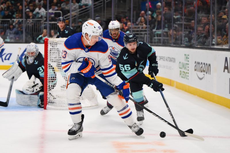 Mar 2, 2024; Seattle, Washington, USA; Edmonton Oilers center Ryan Nugent-Hopkins (93) and Seattle Kraken right wing Kailer Yamamoto (56) play the puck during the first period at Climate Pledge Arena. Mandatory Credit: Steven Bisig-USA TODAY Sports