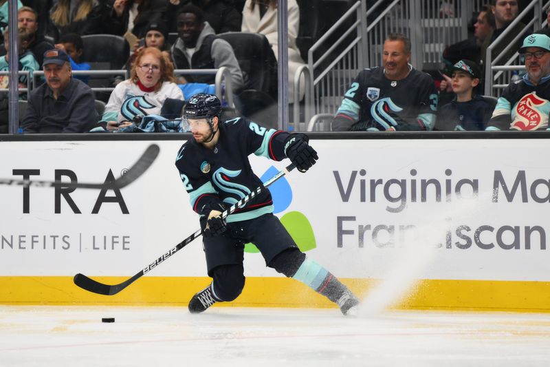 Nov 24, 2023; Seattle, Washington, USA; Seattle Kraken right wing Oliver Bjorkstrand (22) plays the puck during the third period against the Vancouver Canucks at Climate Pledge Arena. Mandatory Credit: Steven Bisig-USA TODAY Sports