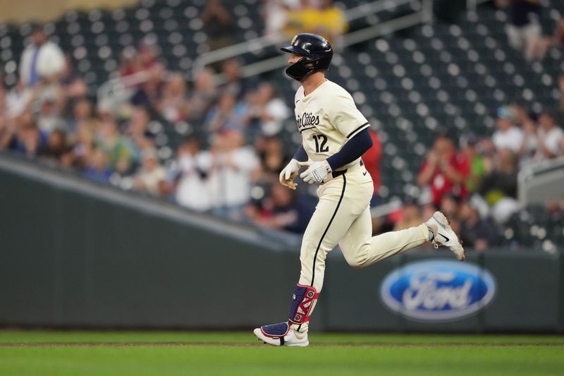 Sep 10, 2024; Minneapolis, Minnesota, USA; Minnesota Twins third baseman Kyle Farmer (12) looks on after hitting a three-run home run during the second inning against the Los Angeles Angels at Target Field. Mandatory Credit: Jordan Johnson-Imagn Images