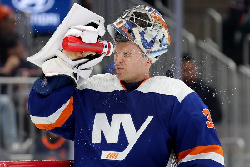 Dec 19, 2023; Elmont, New York, USA; New York Islanders goaltender Ilya Sorokin (30) sprays water on his face during the first period against the Edmonton Oilers at UBS Arena. Mandatory Credit: Brad Penner-USA TODAY Sports
