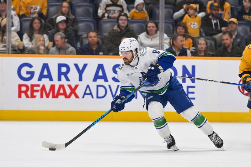 Oct 23, 2025; Nashville, Tennessee, USA;  Vancouver Canucks right wing Conor Garland (8) skates with the puck against the Nashville Predators during the third period at Bridgestone Arena. Mandatory Credit: Steve Roberts-Imagn Images