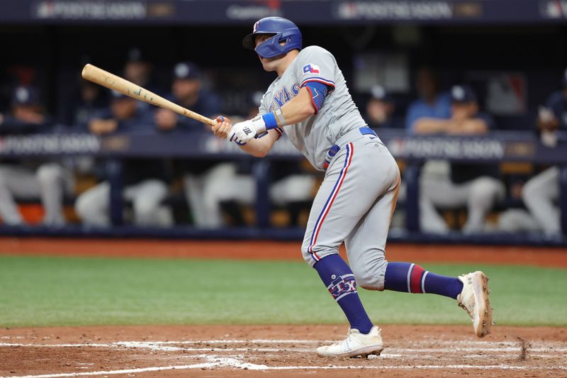 Oct 4, 2023; St. Petersburg, Florida, USA; Texas Rangers third baseman Josh Jung (6) hits a ground rule double against the Tampa Bay Rays in the sixth inning during game two of the Wildcard series for the 2023 MLB playoffs at Tropicana Field. Mandatory Credit: Nathan Ray Seebeck-USA TODAY Sports