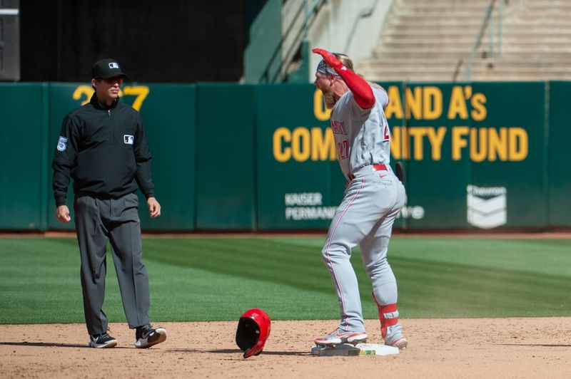 Apr 29, 2023; Oakland, California, USA; Cincinnati Reds right fielder Jake Fraley (27) celebrates after hitting an RBI double during the ninth inning against the Oakland Athletics at RingCentral Coliseum. Mandatory Credit: Ed Szczepanski-USA TODAY Sports