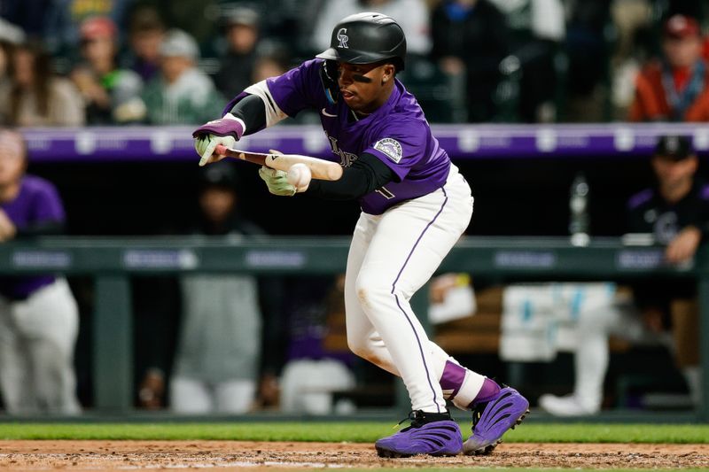 May 19, 2025; Denver, Colorado, USA; Colorado Rockies second baseman Adael Amador (1) sacrifice bunt in the seventh inning against the Philadelphia Phillies at Coors Field. Mandatory Credit: Isaiah J. Downing-Imagn Images
