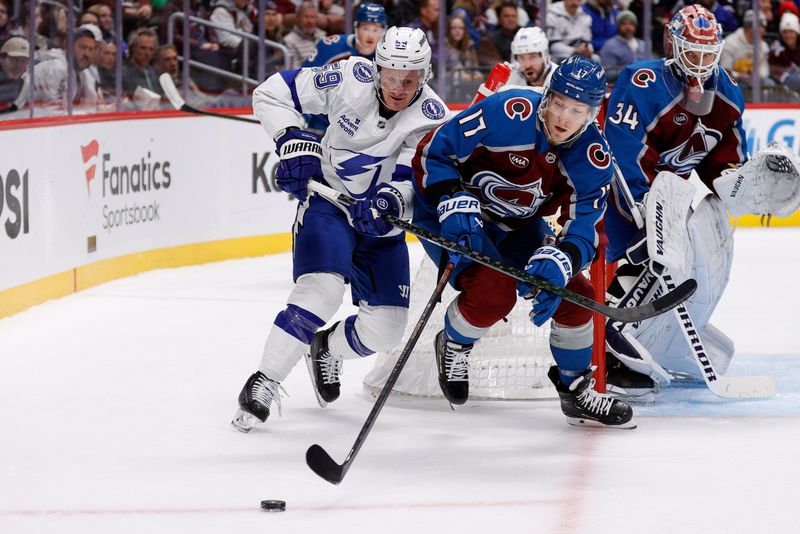 Oct 30, 2024; Denver, Colorado, USA; Colorado Avalanche center Parker Kelly (17) and Tampa Bay Lightning center Jake Guentzel (59) battle for the puck in the first period at Ball Arena. Mandatory Credit: Isaiah J. Downing-Imagn Images