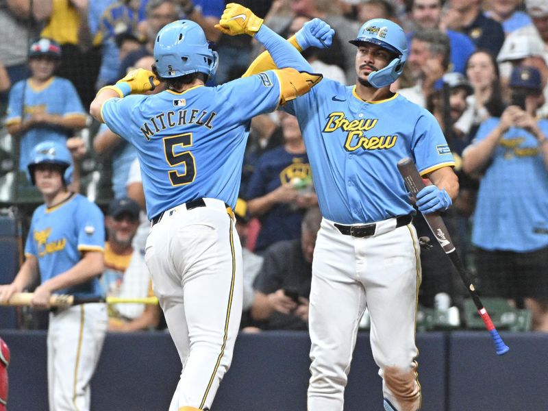 Sep 20, 2024; Milwaukee, Wisconsin, USA; Milwaukee Brewers shortstop Willy Adames (27) celebrates a home run by outfielder Garrett Mitchell (5) during the fifth inning against the Arizona Diamondbacks at American Family Field. Mandatory Credit: Michael McLoone-Imagn Images