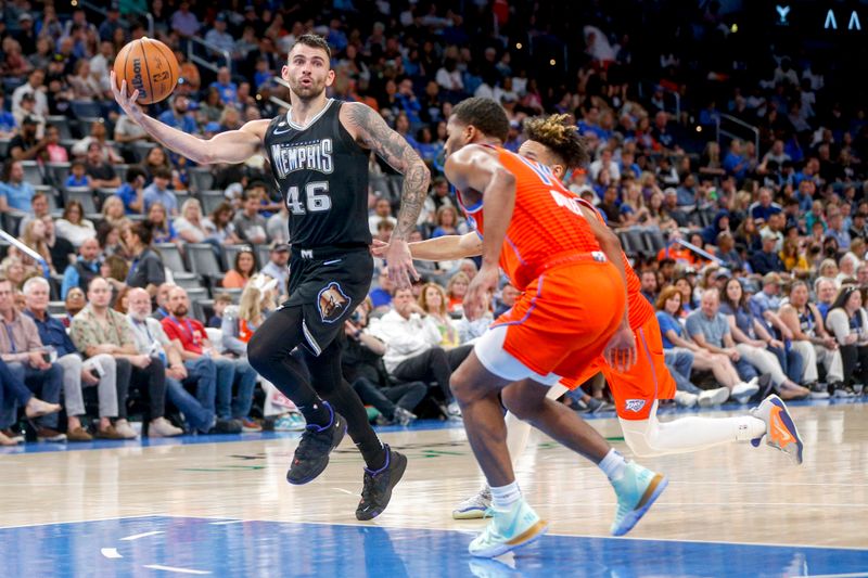 OKLAHOMA CITY, OKLAHOMA - APRIL 09: John Konchar #46 of the Memphis Grizzlies passes the ball past Tre Mann #23 of the Oklahoma City Thunder and Jared Butler #14 of the Oklahoma City Thunder during the second quarter at Paycom Center on April 09, 2023 in Oklahoma City, Oklahoma. NOTE TO USER: User expressly acknowledges and agrees that, by downloading and or using this photograph, User is consenting to the terms and conditions of the Getty Images License Agreement.  (Photo by Ian Maule/Getty Images)