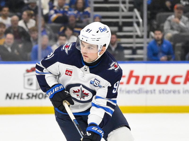 Dec 17, 2025; St. Louis, Missouri, USA; Winnipeg Jets center Cole Perfetti (91) controls the puck against the St. Louis Blues during the first period at Enterprise Center. Mandatory Credit: Jeff Curry-Imagn Images