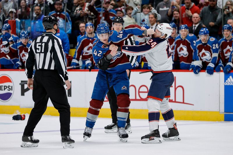 Mar 22, 2024; Denver, Colorado, USA; Colorado Avalanche defenseman Josh Manson (42) and Columbus Blue Jackets right wing Mathieu Olivier (24) fight in the third period at Ball Arena. Mandatory Credit: Isaiah J. Downing-USA TODAY Sports