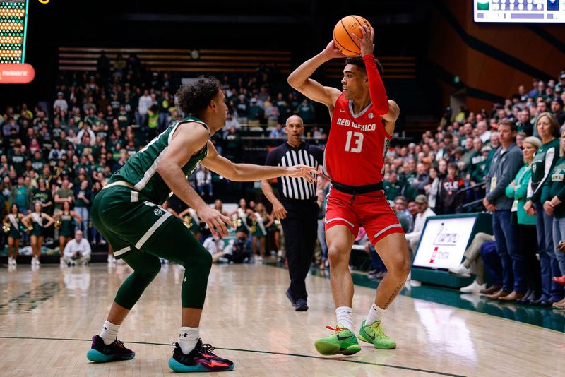 Mar 3, 2023; Fort Collins, Colorado, USA; New Mexico Lobos guard Javonte Johnson (13) controls the ball against Colorado State Rams guard Isaiah Rivera (23) in the first half at Moby Arena. Mandatory Credit: Isaiah J. Downing-USA TODAY Sports