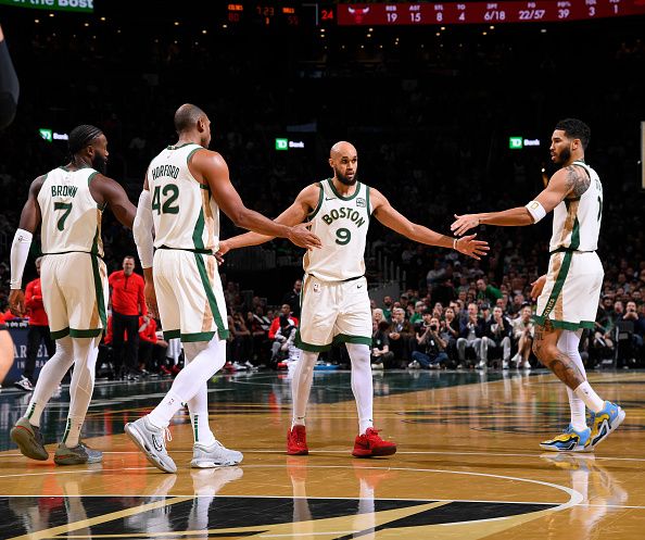 BOSTON, MA - NOVEMBER 28: Derrick White #9, Jaylen Brown #7, Al Horford #42 and Jayson Tatum #0 of the Boston Celtics high five during the game against the Chicago Bulls during the In-Season Tournament on November 28, 2023 at the TD Garden in Boston, Massachusetts. NOTE TO USER: User expressly acknowledges and agrees that, by downloading and or using this photograph, User is consenting to the terms and conditions of the Getty Images License Agreement. Mandatory Copyright Notice: Copyright 2023 NBAE  (Photo by Brian Babineau/NBAE via Getty Images)