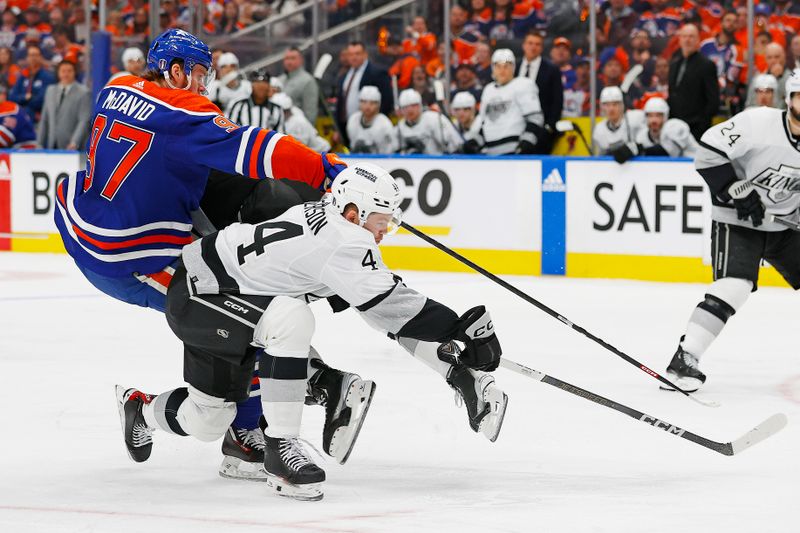 Apr 22, 2024; Edmonton, Alberta, CAN; Los Angeles Kings defensemen Mikey Anderson (44) trips up Edmonton Oilers forward Connor McDavid (97) during the third period in game one of the first round of the 2024 Stanley Cup Playoffs at Rogers Place. Mandatory Credit: Perry Nelson-USA TODAY Sports