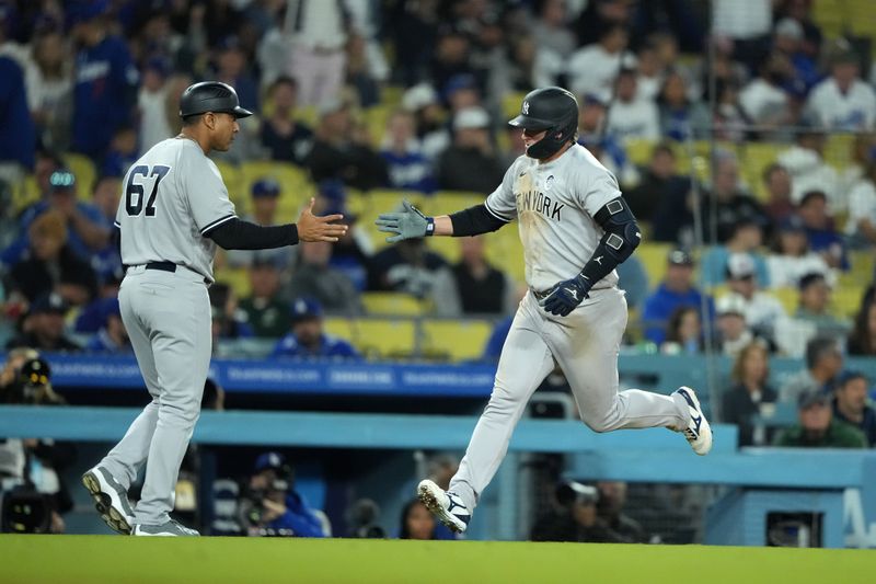 Jun 2, 2023; Los Angeles, California, USA; New York Yankees third baseman Josh Donaldson (28) celebrates with third base coach Luis Rojas (67) after hitting a solo home run in the ninth inning against the Los Angeles Dodgers at Dodger Stadium. Mandatory Credit: Kirby Lee-USA TODAY Sports