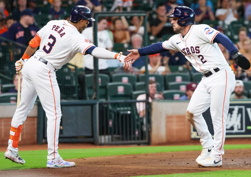 Jun 25, 2024; Houston, Texas, USA; Houston Astros shortstop Jeremy Pena (3) celebrates with third baseman Alex Bregman (2) against the Colorado Rockies in the first inning at Minute Maid Park. Mandatory Credit: Thomas Shea-USA TODAY Sports