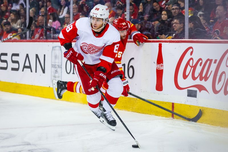 Feb 17, 2024; Calgary, Alberta, CAN; Detroit Red Wings right wing Patrick Kane (88) controls the puck against Calgary Flames defenseman Noah Hanifin (55) during the second period at Scotiabank Saddledome. Mandatory Credit: Sergei Belski-USA TODAY Sports