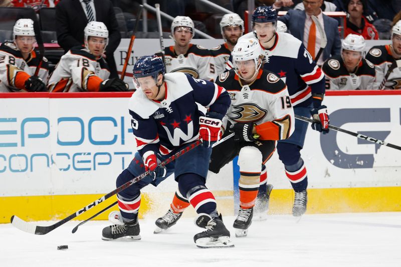 Jan 16, 2024; Washington, District of Columbia, USA; Washington Capitals defenseman Nick Jensen (3) skates with the puck as Anaheim Ducks right wing Troy Terry (19) chases in the first period at Capital One Arena. Mandatory Credit: Geoff Burke-USA TODAY Sports