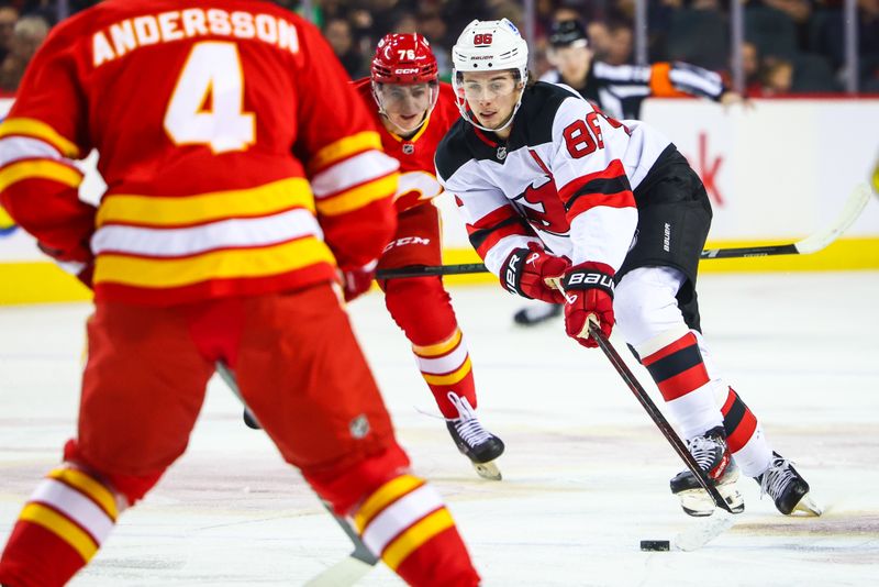 Nov 1, 2024; Calgary, Alberta, CAN; New Jersey Devils center Jack Hughes (86) controls the puck against the Calgary Flames during the first period at Scotiabank Saddledome. Mandatory Credit: Sergei Belski-Imagn Images