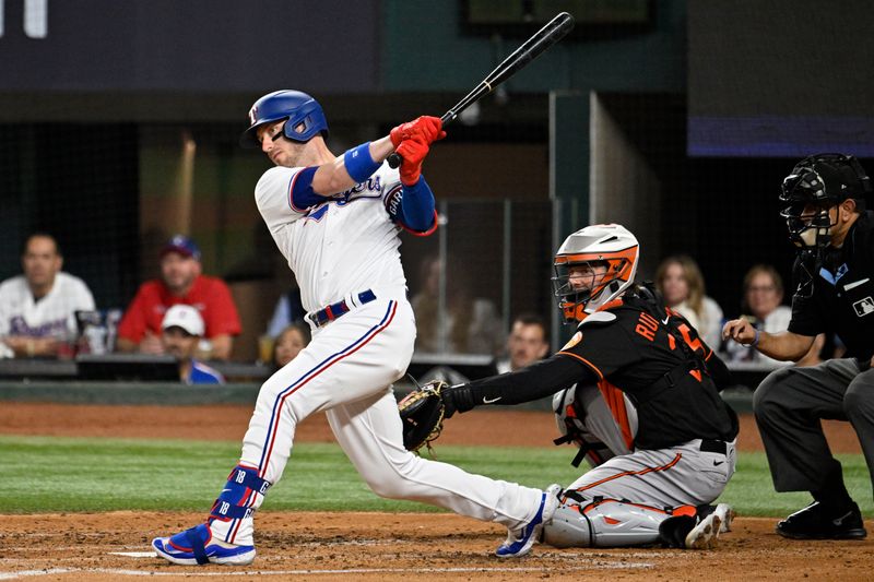 Oct 10, 2023; Arlington, Texas, USA; Texas Rangers catcher Mitch Garver (18) hits an RBI double in the second inning against the Baltimore Orioles during game three of the ALDS for the 2023 MLB playoffs at Globe Life Field. Mandatory Credit: Jerome Miron-USA TODAY Sports