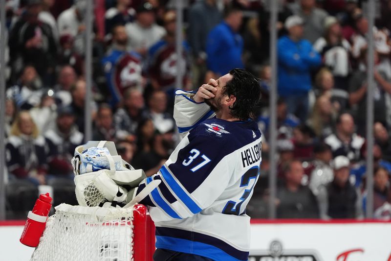 Apr 28, 2024; Denver, Colorado, USA; Winnipeg Jets goaltender Connor Hellebuyck (37) reacts following a goal scored by the Colorado Avalanche in the second period in game four of the first round of the 2024 Stanley Cup Playoffs at Ball Arena. Mandatory Credit: Ron Chenoy-USA TODAY Sports