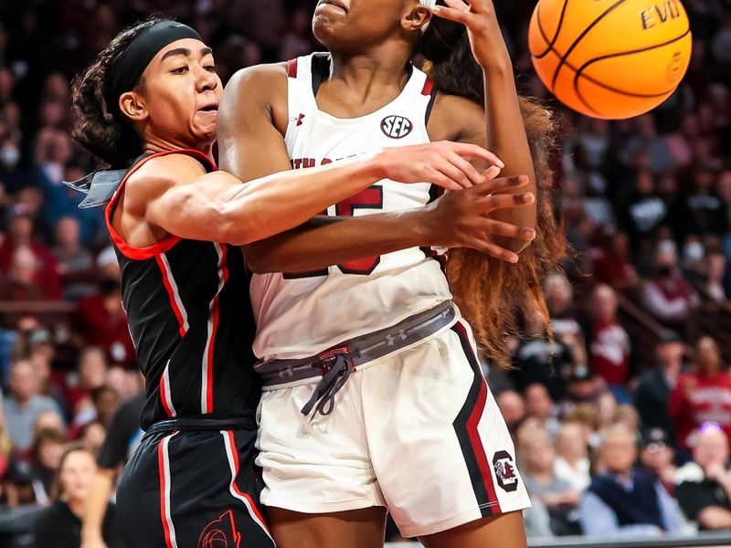 Feb 26, 2023; Columbia, South Carolina, USA; South Carolina Gamecocks guard Raven Johnson (25) is fouled by Georgia Lady Bulldogs guard Chloe Chapman (1) in the first half at Colonial Life Arena. Mandatory Credit: Jeff Blake-USA TODAY Sports