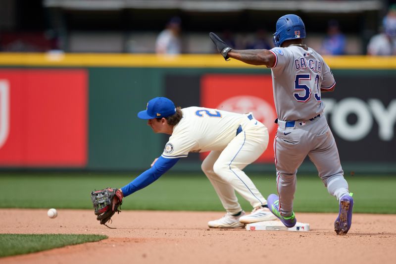 Aug 3, 2025; Seattle, Washington, USA; Seattle Mariners second baseman Cole Young (2) reaches for the ball to force Texas Rangers shortstop Corey Seager (5) out at second during the ninth inning at T-Mobile Park. Mandatory Credit: John Froschauer-Imagn Images