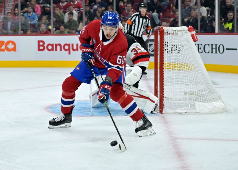 Sep 24, 2024; Montreal, Quebec, CAN; Montreal Canadiens forward Florian Xhekaj (60) plays the puck against the New Jersey Devils during the first period at the Bell Centre. Mandatory Credit: Eric Bolte-Imagn Images