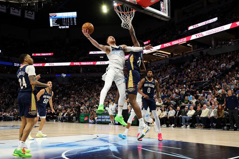 MINNEAPOLIS, MINNESOTA - MARCH 21: Donte DiVincenzo #0 of the Minnesota Timberwolves goes up for a shot against Yves Missi #21 of the New Orleans Pelicans in the fourth quarter at Target Center on March 21, 2025 in Minneapolis, Minnesota. The Timberwolves defeated the Pelicans 134-93. NOTE TO USER: User expressly acknowledges and agrees that, by downloading and or using this photograph, User is consenting to the terms and conditions of the Getty Images License Agreement. (Photo by David Berding/Getty Images)