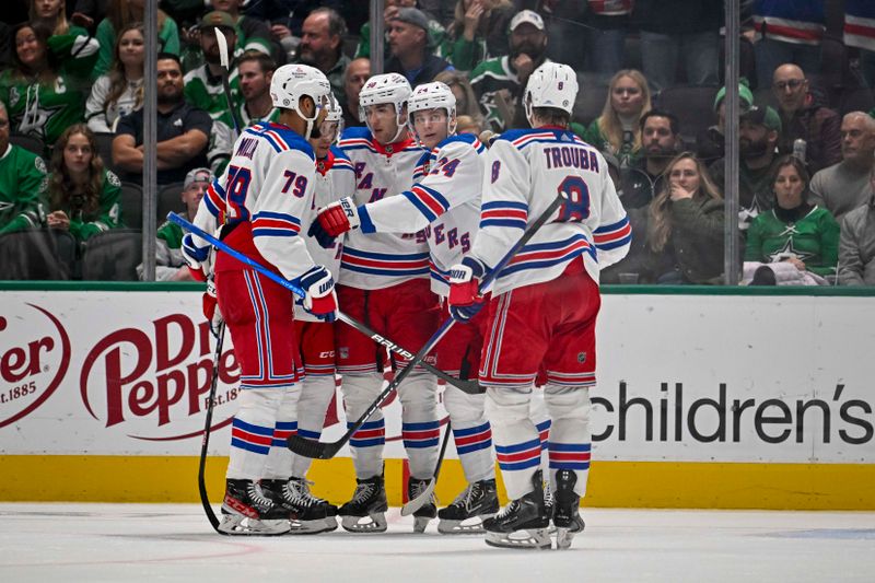 Nov 20, 2023; Dallas, Texas, USA; New York Rangers defenseman K'Andre Miller (79) and left wing Will Cuylle (50) and right wing Kaapo Kakko (24) and defenseman Jacob Trouba (8) celebrates a goal scored by Kakko against the Dallas Stars during the second period at the American Airlines Center. Mandatory Credit: Jerome Miron-USA TODAY Sports