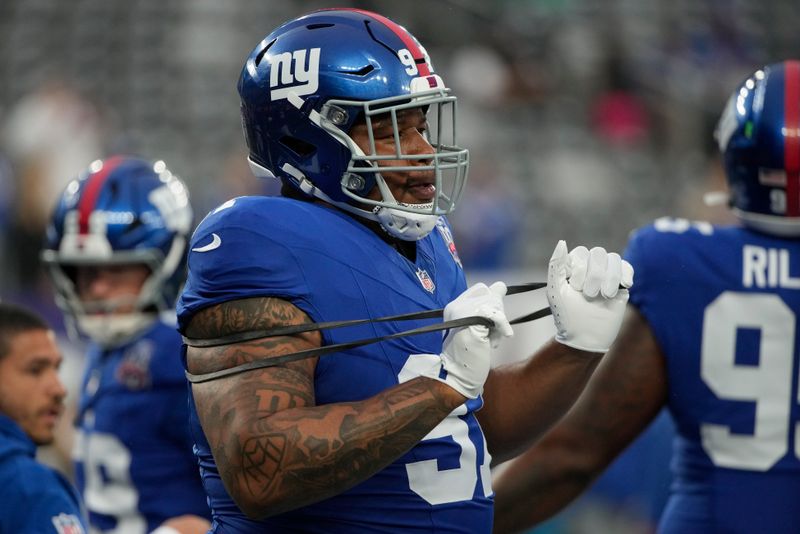 New York Giants defensive tackle Dexter Lawrence II (97) warms up before playing against the Detroit Lions in an NFL football game, Thursday, Aug. 8, 2024, in East Rutherford, N.J. (AP Photo/Pamela Smith)