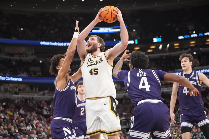 Mar 12, 2026; Chicago, IL, USA; Northwestern Wildcats guard Jayden Reid (4) defends Purdue Boilermakers center Oscar Cluff (45) during the first half at United Center. Mandatory Credit: David Banks-Imagn Images