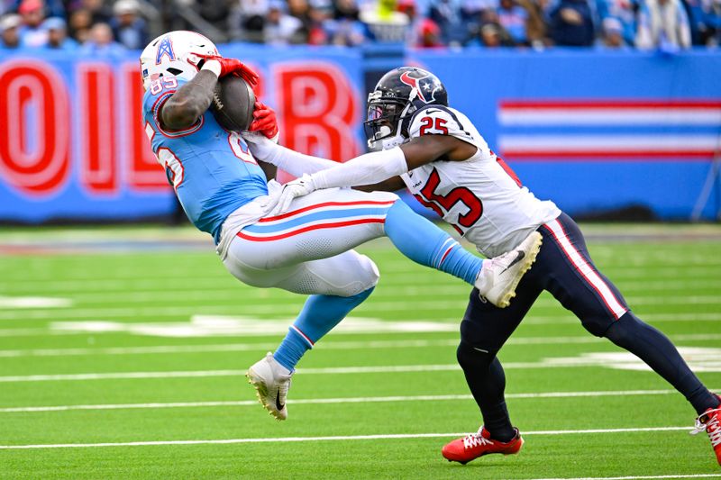 Tennessee Titans tight end Chigoziem Okonkwo (85) makes a catch as Houston Texans cornerback Desmond King II (25) defends in an NFL football game Sunday, Dec. 17, 2023, in Nashville, Tenn. (AP Photo/John Amis)