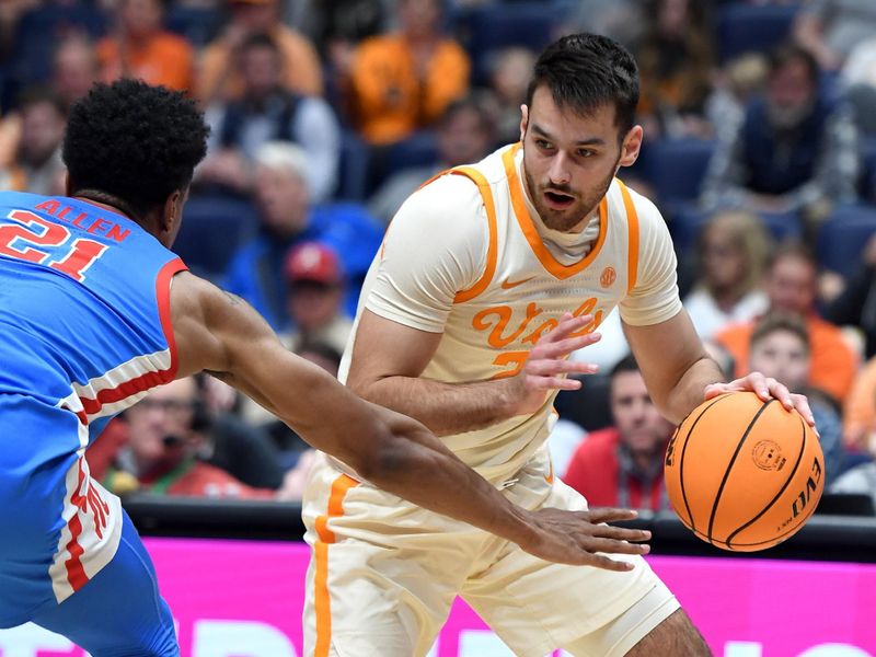 Mar 9, 2023; Nashville, TN, USA; Tennessee Volunteers guard Santiago Vescovi (25) steals the ball from Mississippi Rebels forward Robert Allen (21) during the second half at Bridgestone Arena. Mandatory Credit: Christopher Hanewinckel-USA TODAY Sports