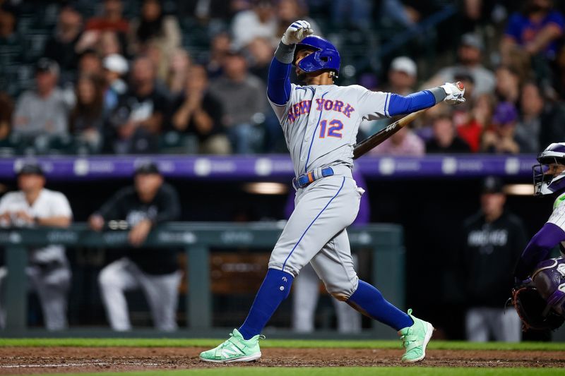 May 26, 2023; Denver, Colorado, USA; New York Mets shortstop Francisco Lindor (12) watches his ball on a sacrifice fly RBI in the ninth inning against the Colorado Rockies at Coors Field. Mandatory Credit: Isaiah J. Downing-USA TODAY Sports