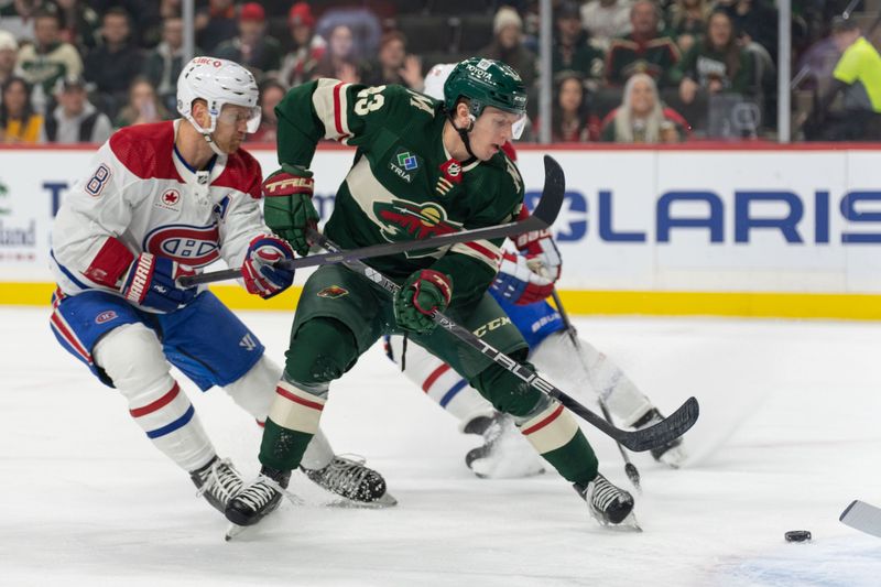 Dec 21, 2023; Saint Paul, Minnesota, USA; Minnesota Wild center Marco Rossi (23) shoots Montreal Canadiens defenseman Mike Matheson (8) on defense in the first period at Xcel Energy Center. Mandatory Credit: Matt Blewett-USA TODAY Sports