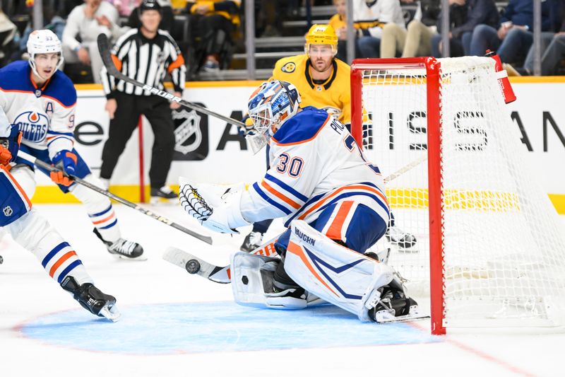 Oct 17, 2024; Nashville, Tennessee, USA;  Edmonton Oilers goaltender Calvin Pickard (30) blocks the shot of Nashville Predators center Jonathan Marchessault (81) during the third period at Bridgestone Arena. Mandatory Credit: Steve Roberts-Imagn Images