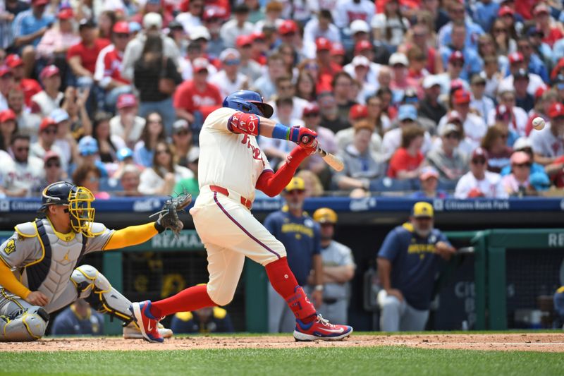 Jun 1, 2025; Philadelphia, Pennsylvania, USA; Philadelphia Phillies outfielder Kyle Schwarber (12) hits an RBI single during the second inning against the Milwaukee Brewers at Citizens Bank Park. Mandatory Credit: Eric Hartline-Imagn Images