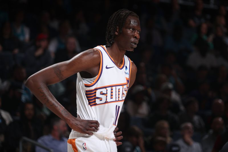 CHARLOTTE, NC - MARCH 15:  Bol Bol #11 of the Phoenix Suns looks on during the game on March 15, 2024 at Spectrum Center in Charlotte, North Carolina. NOTE TO USER: User expressly acknowledges and agrees that, by downloading and or using this photograph, User is consenting to the terms and conditions of the Getty Images License Agreement.  Mandatory Copyright Notice:  Copyright 2024 NBAE (Photo by Nathaniel S. Butler/NBAE via Getty Images)