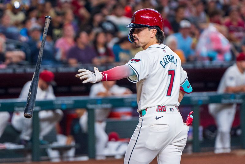 Aug 10, 2024; Phoenix, Arizona, USA; Arizona Diamondbacks outfielder Corbin Carroll (7) reaches out to catch his bat after striking out in the first inning against the Philadelphia Phillies at Chase Field. Mandatory Credit: Allan Henry-USA TODAY Sports  