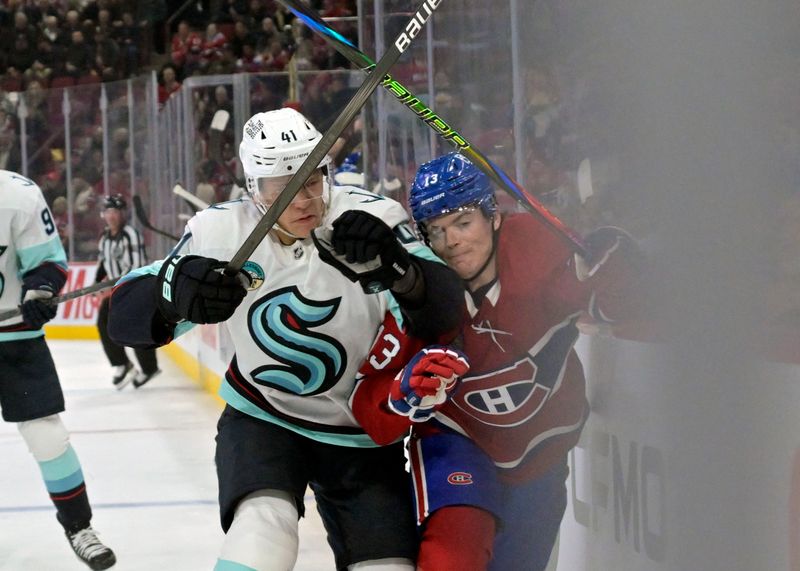Oct 29, 2024; Montreal, Quebec, CAN; Seattle Kraken defenseman Ryker Evans (41) checks Montreal Canadiens forward Cole Caufield (13) during the second period at the Bell Centre. Mandatory Credit: Eric Bolte-Imagn Images