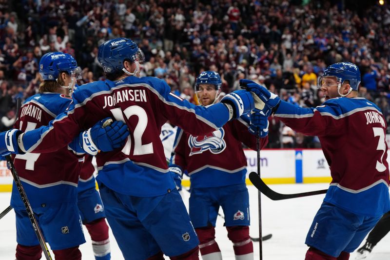 Feb 20, 2024; Denver, Colorado, USA; Colorado Avalanche center Ryan Johansen (12) celebrates his goal with defenseman Jack Johnson (3) in the second period against the Vancouver Canucks at Ball Arena. Mandatory Credit: Ron Chenoy-USA TODAY Sports