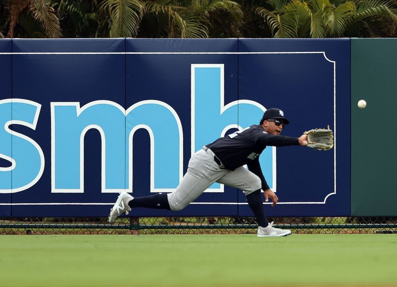 Mar 2, 2024; Sarasota, Florida, USA; New York Yankees center fielder Trent Grisham (12) catches a fly ball during the fourth inning against the Baltimore Orioles at Ed Smith Stadium. Mandatory Credit: Kim Klement Neitzel-USA TODAY Sports