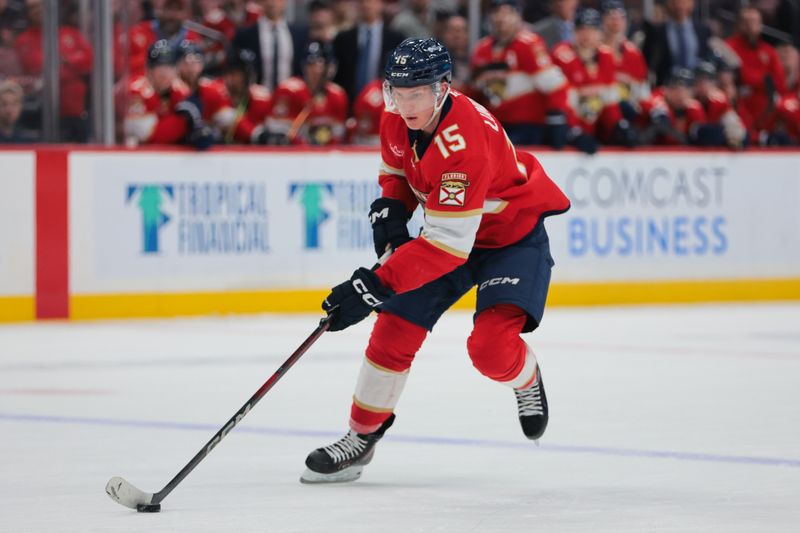 Jan 18, 2025; Sunrise, Florida, USA; Florida Panthers center Anton Lundell (15) moves the puck against the Anaheim Ducks during the first period at Amerant Bank Arena. Mandatory Credit: Sam Navarro-Imagn Images